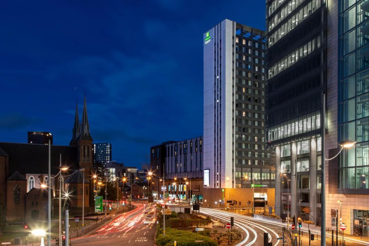 a city street at night with a tall building at Holiday Inn Express Birmingham - Snow Hill by IHG in Birmingham