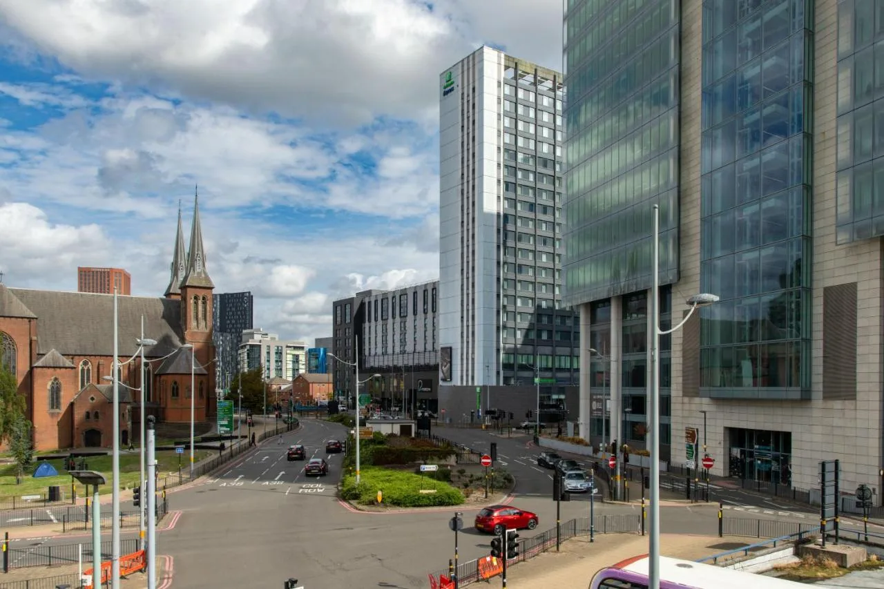 a city street with tall buildings and a church at Holiday Inn Express Birmingham - Snow Hill by IHG in Birmingham